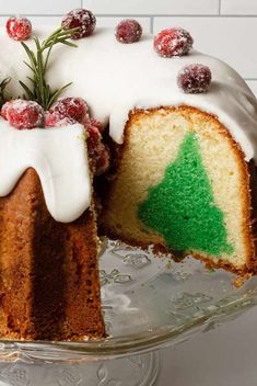 a cake with white frosting and a green christmas tree decoration on the top slice