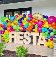 there is a sign that says fiesta with balloons all over it