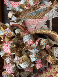 a basket filled with lots of different colored pieces of paper on top of a wooden table