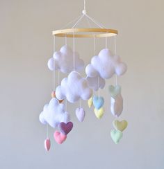 a mobile with clouds and hearts hanging from it