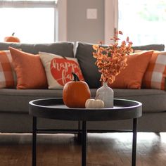 a living room filled with furniture and lots of pillows on top of the couches