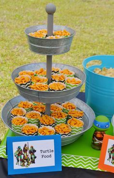 a table topped with lots of food and cupcakes