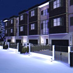 a row of apartment buildings at night with snow on the ground