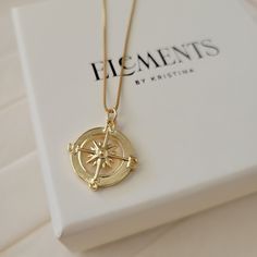 "Round gold compass pendant necklace. Wear it on it's own or layer it. Crafted on sturdy non tarnish 14K gold filled box chain. Pendant details: * Finish: non tarnish 14K gold filled * Size: 23mm x 19mm Comes in our gift ready packaging: vegan leather pouch for safe jewelry storing and branded box Packaged and shipped with care from our studio located in sunny Tampa, FL GOLD FILLED Tarnish Resistant. Hypoallergenic. Long Lasting. Gold filled is affordable alternative to solid gold. Hypoallergeni Gold Compass Necklace, Compass Pendant Necklace, Coordinates Jewelry, North Star Necklace, Travel Necklace, Star Necklace Gold, Compass Pendant, Compass Necklace, Jewelry Words