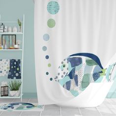 a shower curtain with fish on it in a blue and white bathroom, next to shelves