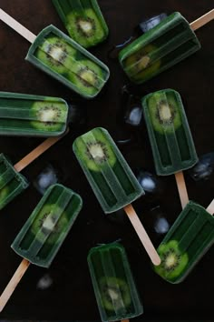 several popsicles with kiwi slices on them and ice cream sticks in the middle