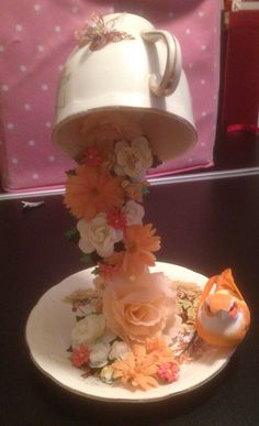 a white plate topped with flowers and a tea pot