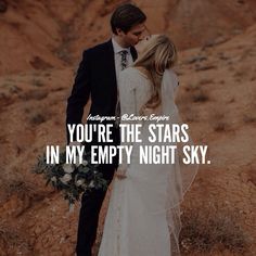 a bride and groom kissing in the desert with text that reads, you're the stars in my empty night sky