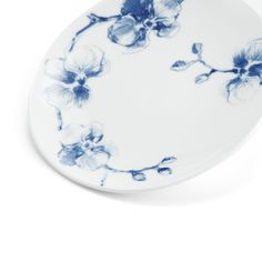 a blue and white plate with flowers on it