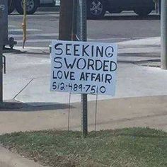 a sign that says seeking sworded love affair is posted on the side of a street