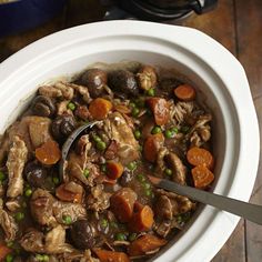 a white bowl filled with meat and vegetables