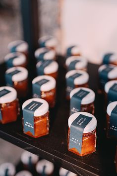 several jars of honey sit on a table