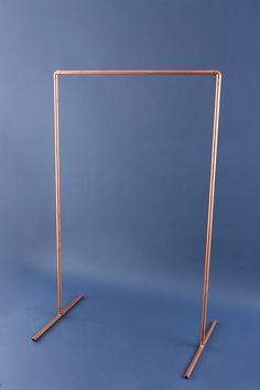 a copper colored metal frame with two legs