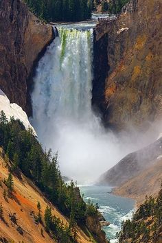 a large waterfall in the middle of a canyon