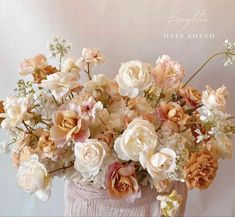 a vase filled with lots of flowers on top of a table