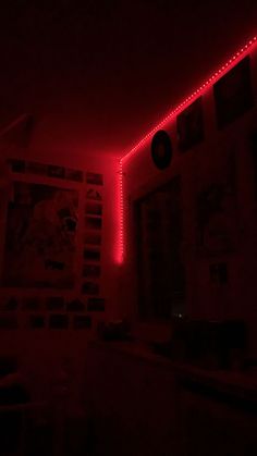 a dark room with red lights on the wall