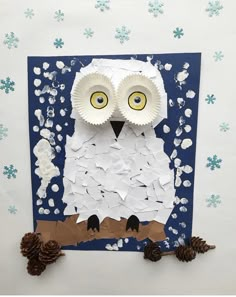 an owl made out of paper and some pine cones