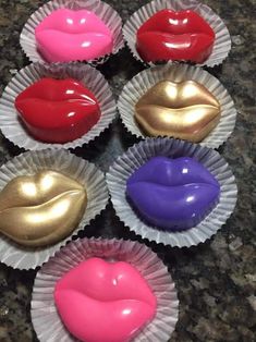 six chocolates with different colored lips in them on a counter top next to each other