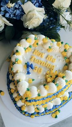 a birthday cake with flowers on the side and congratulations written in frosted icing