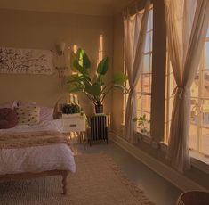 a bed room with a neatly made bed next to two windows and a potted plant