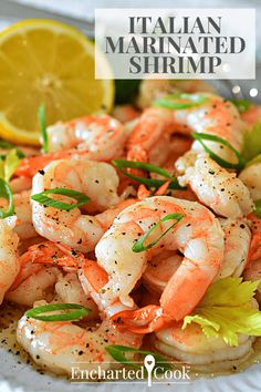 a plate full of cooked shrimp and garnished with herbs, lemon wedges and parsley