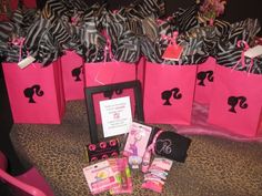 pink bags with black and white silhouettes are on display in front of a leopard print chair