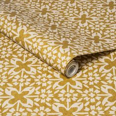 a yellow and white wallpaper with an intricate design on it's surface,