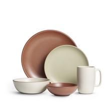 an assortment of dishes and cups on a white background with brown rimmed plates, mugs and saucers