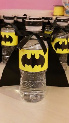 some water bottles are decorated like batman's and have black ribbon around the top