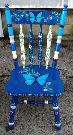 a blue chair with butterflies painted on it