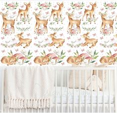 a baby's crib with deer wallpaper and pink flowers in the background