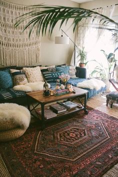 a living room filled with lots of furniture and rugs on top of a wooden floor