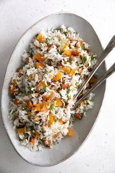 a white bowl filled with rice and carrots