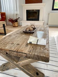 a wooden table sitting on top of a white rug