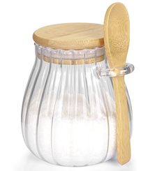 a wooden spoon in a glass jar filled with sugar