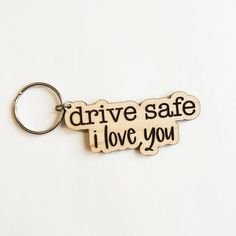 a wooden keychain that says drive safe i love you