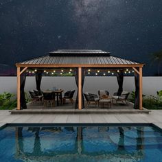 a gazebo with string lights on it next to a swimming pool