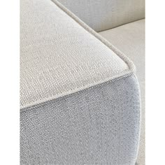 an upholstered couch with white fabric