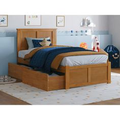 a bed with two drawers underneath it in a child's playroom or bedroom