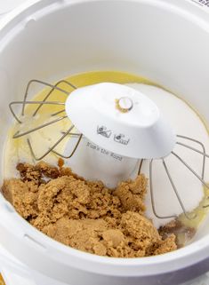 a food processor filled with brown stuff on top of a table