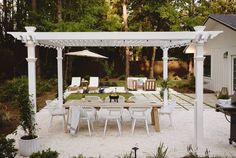 an outdoor dining area with table and chairs