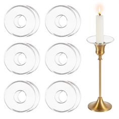 six glass plates and a candle on a stand