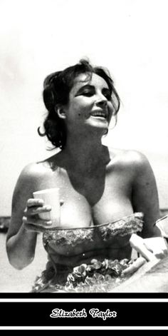 a woman in a bathing suit holding a cup