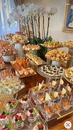 an assortment of desserts and pastries on display at a wedding or bridal party