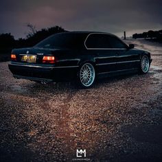 a black car parked on the side of a road