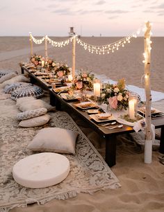 a long table set up on the beach for dinner