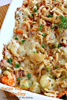 a casserole dish with vegetables and meat in it