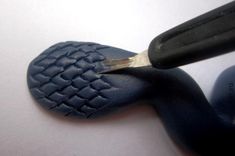 a pair of scissors cutting through the side of a shoe