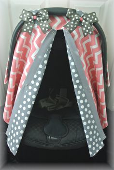 a car seat cover with polka dots and bows