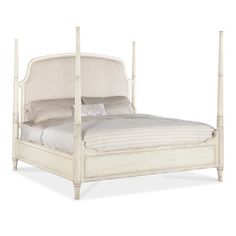 a white bed with an upholstered headboard and foot board on the side